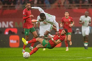| Photo: AP/Mosa'ab Elshamy : Morocco's Jawad El Yamiq tackles Comoros' Rafiki Saïd Ahamada during the Africa Cup of Nations group A soccer match between Morocco and Comoros in Rabat, Morocco.