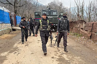 | Photo: PTI : Security officials keep vigil during a search and cordon operation, in Salia village of Anantnag district.