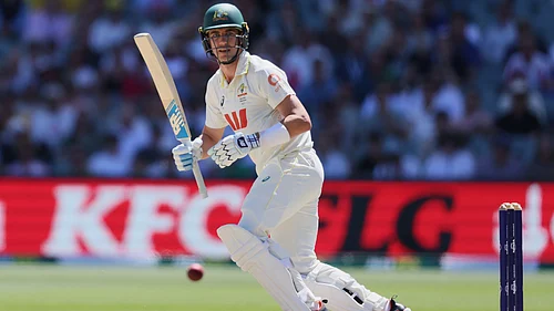 | Photo: AP/James Elsby : Australias Pat Cummins bats during play on day four of the third Ashes cricket test between England and Australia in Adelaide, Australia, Saturday, Dec. 20, 2025.