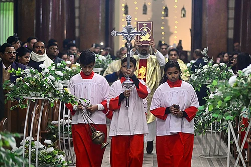 Photo: PTI : Prayagraj: People from the Christian community during the Christmas midnight mass at St. Josephs Cathedral, in Prayagraj, Wednesday night, Dec. 24, 2025. (PTI Photo)(PTI12_25_2025_000019B)
