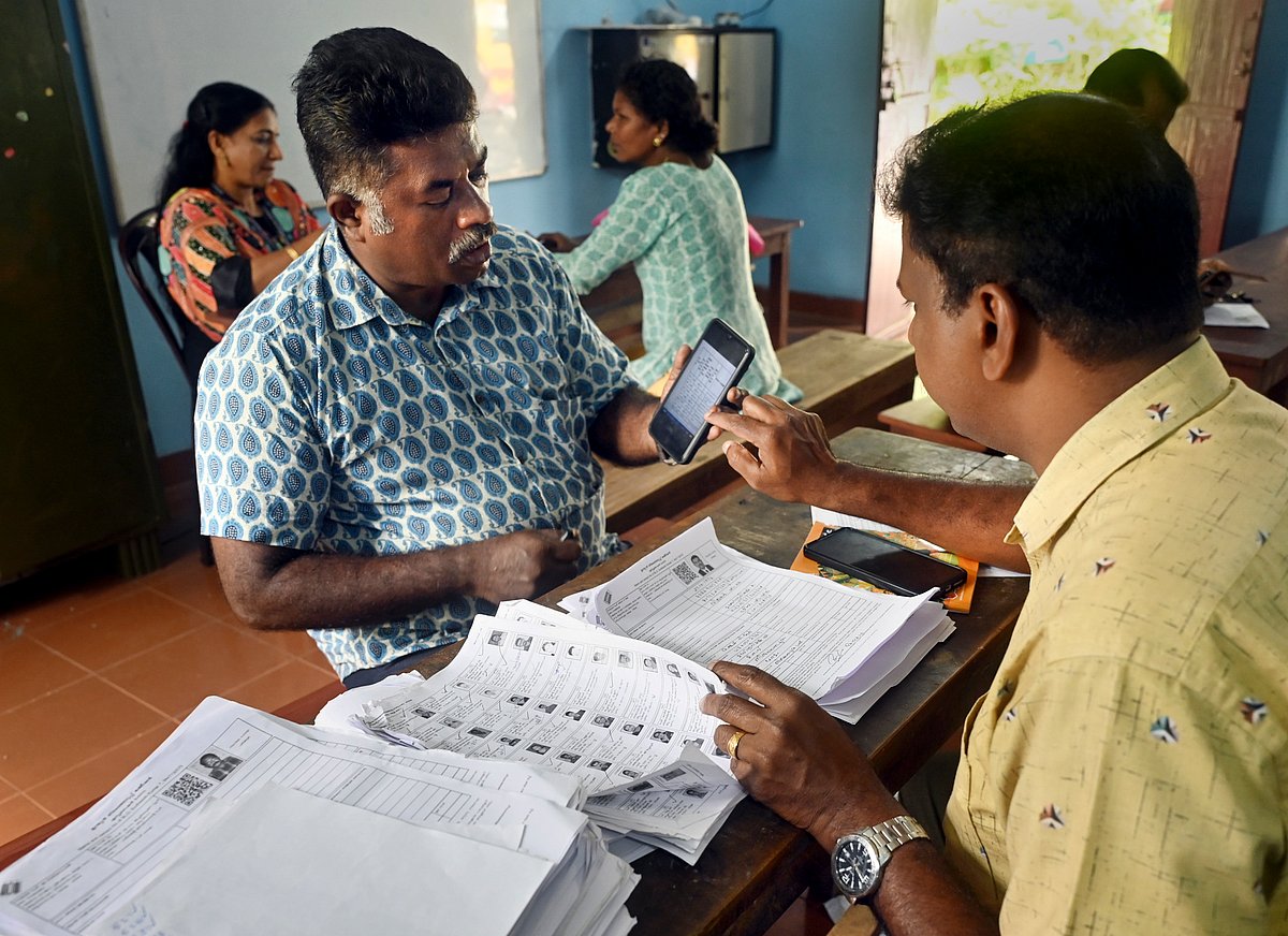  PTI                                : A Booth Level Officer (BLO) interacts with a voter as he checks and collects filled enumeration forms for the special intensive revision (SIR) of electoral rolls, in Thiruvananthapuram,