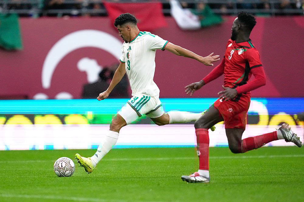 | Photo: AP/Mosaab Elshamy : Algerias Baghdad Bounedjah attempts a shot next to Sudans Mohamed Saeed Ahmed during the Africa Cup of Nations group E soccer match between Algeria and Sudan in Rabat, Morocco.