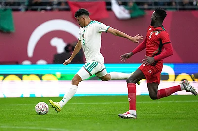 | Photo: AP/Mosaab Elshamy : Algerias Baghdad Bounedjah attempts a shot next to Sudans Mohamed Saeed Ahmed during the Africa Cup of Nations group E soccer match between Algeria and Sudan in Rabat, Morocco.