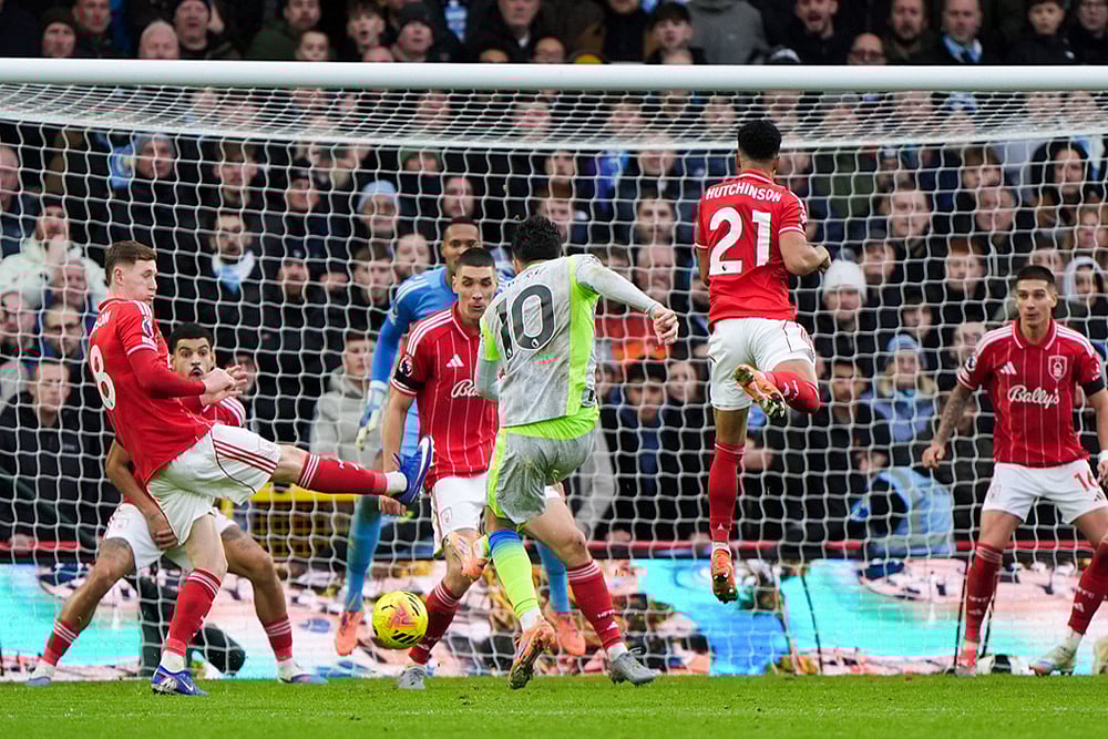 | Photo: Joe Giddens/PA via AP : Manchester Citys Rayan Cherki scores his sides second goal during the Premier League match between Nottingham Forest and Manchester City, in Nottingham, England.