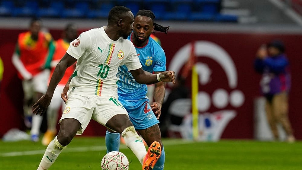 Photo: AP/Themba Hadebe : Senegal's Sadio Mane is challenged by DR Congo's Aaron Wan-Bissaka during the Africa Cup of Nations group D soccer match between Senegal and DR Congo in Tangier, Morocco.