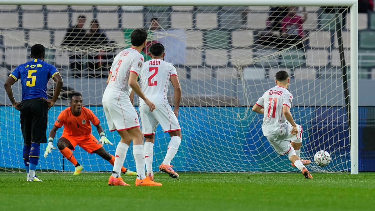 (AP Photo/Mosa'ab Elshamy) : Tunisia's Ismael Gharbi, right, scores from a penalty kick during the Africa Cup of Nations group C soccer match between Tanzania and Tunisia in Rabat, Morocco, Tuesday, Dec. 30, 2025.