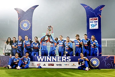 | Photo: PTI : Indias players celebrate with the trophy after winning the T20 International cricket match series against Sri Lanka at the Greenfield International Stadium in Thiruvananthapuram, Kerala. India Women won by 15 runs.