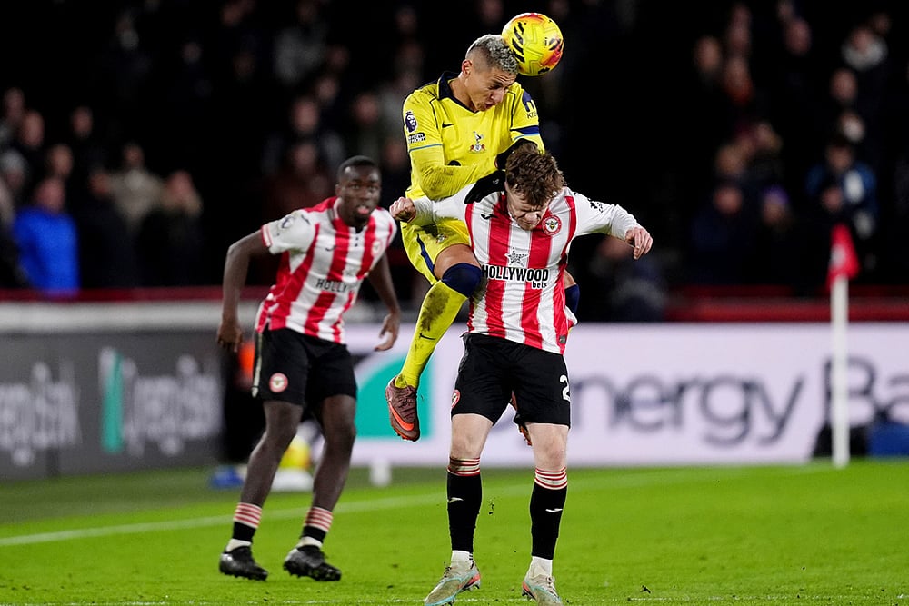 | Photo: John Walton/PA via AP : Tottenham Hotspurs Richarlison and Brentfords Keane Lewis-Potter, right, in action during the English Premier League soccer match between Brentford and Tottenham Hotspur in London.