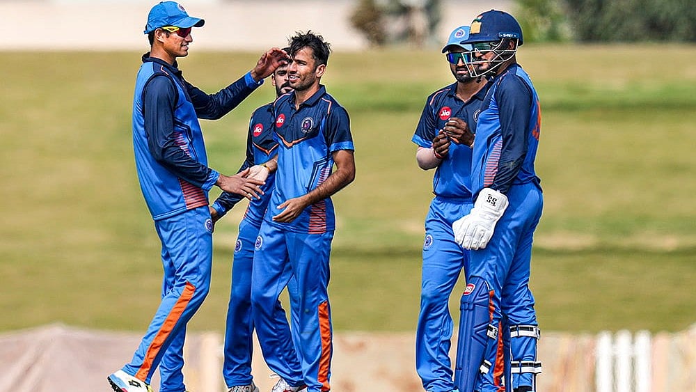 | Photo: PTI/Shailendra Bhojak : Gujarats Ravi Bishnoi, centre, with teammates celebrates after taking the wicket of Delhis Ayush Badoni during the Vijay Hazare Trophy 2025-26 cricket match between Gujarat and Delhi, at BCCI Centre of Excellence Ground, in Bengaluru.