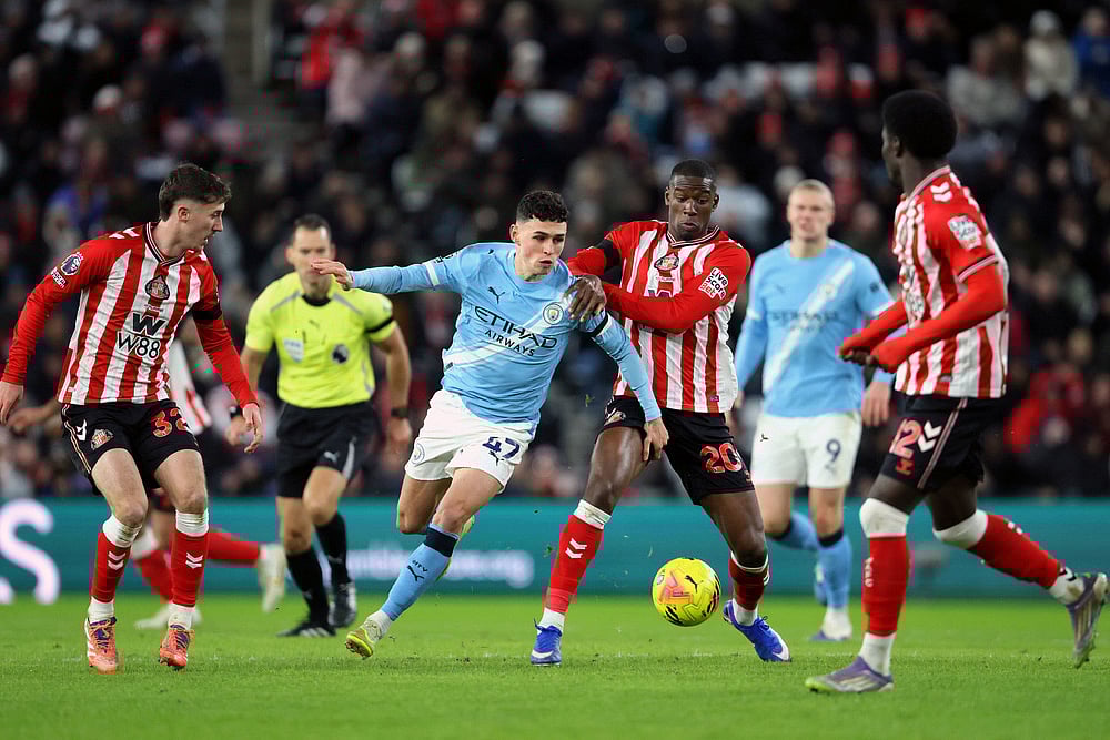 | Photo: Richard Sellers/PA via AP : Manchester Citys Phil Foden, center left, and Sunderlands Nordi Mukiele in action during the English Premier League soccer match between Sunderland and Manchester City in Sunderland, England.