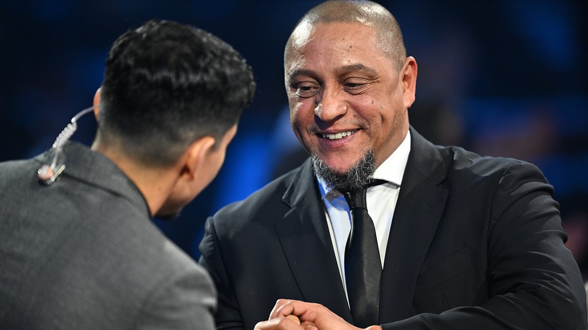 | Photo: Pool/Mandel Ngan via AP : Former Brazil star Roberto Carlos is interviewed by actor Danny Ramirez during the draw for the 2026 soccer World Cup at the Kennedy Center in Washington, Friday, Dec. 5, 2025. 