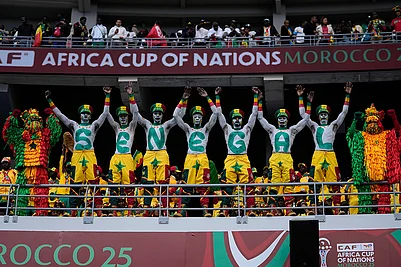 | Photo: AP/Themba Hadebe : Senegal fans support their national team during the Africa Cup of Nations group D soccer match between Senegal and DR Congo in Tangier, Morocco, Saturday, Dec. 27, 2025.