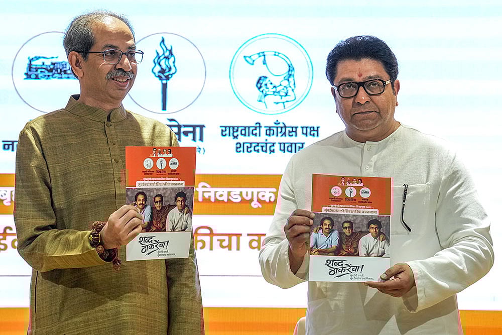 | Photo: PTI/Kunal Patil : Shiv Sena (UBT) chief Uddhav Thackeray, left, and Maharashtra Navnirman Sena (MNS) chief Raj Thackeray release their alliance manifesto for the upcoming civic polls, at Sena Bhavan, in Mumbai.