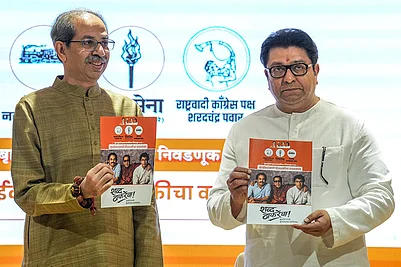 | Photo: PTI/Kunal Patil : Shiv Sena (UBT) chief Uddhav Thackeray, left, and Maharashtra Navnirman Sena (MNS) chief Raj Thackeray release their alliance manifesto for the upcoming civic polls, at Sena Bhavan, in Mumbai.