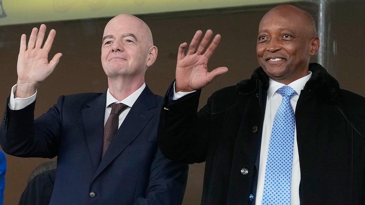 | Photo: AP/Themba Hadebe : CAF President Patrice Motsepe and FIFA President Gianni Infantino wave from the tribune during the Africa Cup of Nations round of 16 soccer match between South Africa and Cameroon in Rabat, Morocco, Sunday, Jan. 4, 2026.