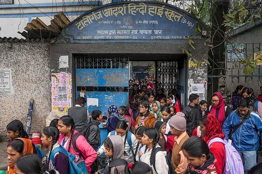 | Photo: PTI : Students with their parents outside Tollygunge Adarsha Hindi High School amid concerns over the dilapidated condition of government schools, in Kolkata.