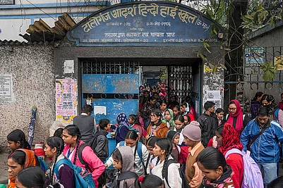 | Photo: PTI : Students with their parents outside Tollygunge Adarsha Hindi High School amid concerns over the dilapidated condition of government schools, in Kolkata.