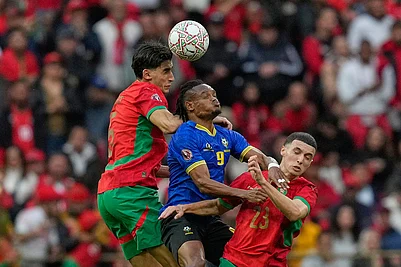 | Photo: AP/Mosaab Elshamy : Tanzanias Selamani Mwalimu, center, fights for the ball with Moroccos Nayef Aguerd, left and Bilal El Khannouss during the Africa Cup of Nations round of 16 soccer match between Morocco and Tanzania in Rabat, Morocco.