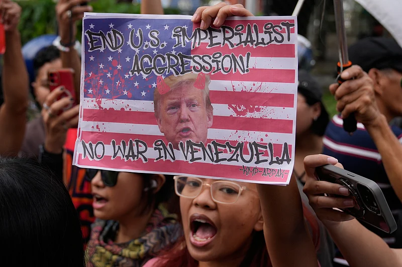 Aaron Favila : Protesters shout slogans while holding a picture of U.S. President Donald Trump as they denounce the U.S. government and Trump after the U.S. captured Venezuelan President Nicolas Maduro during a rally near the U.S. Embassy in Manila, Philippines on Monday
