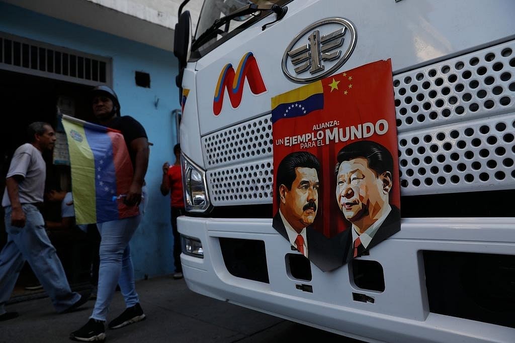 AP Photo/Cristian Hernandez : A banner on the front end of a bus features images of Venezuelan President Nicolas Maduro and Chinas Xi Jinping with a message that reads in Spanish: An example for the world, during a government-organized rally opposing U.S. intervention, in Caracas, Venezuela.