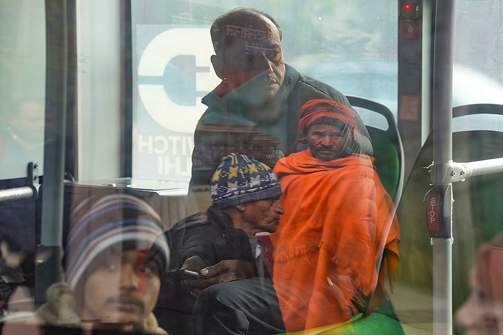 | Photo: PTI/Shahbaz Khan : Passengers commute by bus on a cold winter morning, in New Delhi.