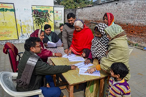 | Photo: PTI : People search for their names in the draft voter list after the Special Intensive Revision of electoral rolls in Uttar Pradesh, in Mirzapur, Uttar Pradesh.