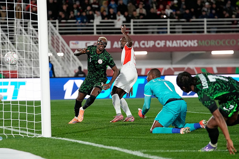 | Photo: AP/Themba Hadebe : Nigerias Victor Osimhen, left, celebrates after scoring his sides third goal during the Africa Cup of Nations round of 16 soccer match between Nigeria and Mozambique in Fez, Morocco.