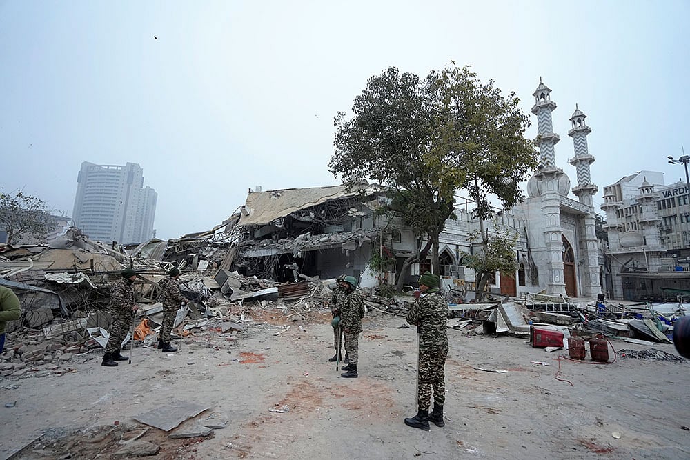 | Photo: PTI/Shahbaz Khan : Security personnel stand guard outside the Syed Faiz Elahi mosque after the demolition of alleged encroachments from a land adjoining the mosque carried out by the Municipal Corporation of Delhi (MCD), at Turkman Gate area, in New Delhi.