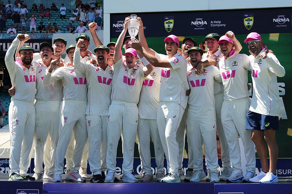 | Photo: AP/Mark Baker : Australian team celebrate with the Ashes trophy following the final Ashes cricket test between England and Australia in Sydney, Australia.