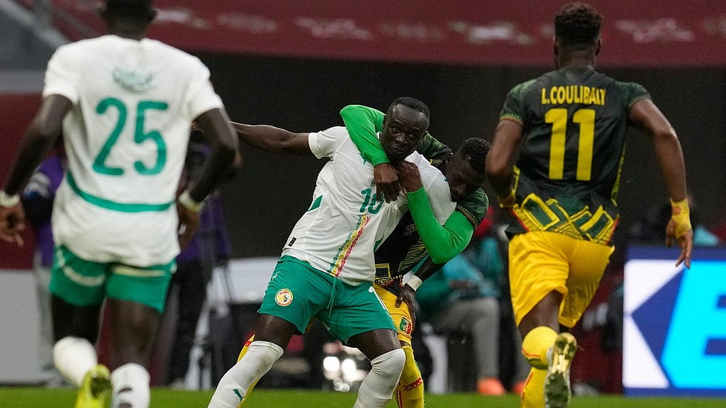 Photo: AP : Mali's Hamari Traore, background, holds Senegal's Sadio Mane during the Africa Cup of Nations quarter-final match in Tangier.
