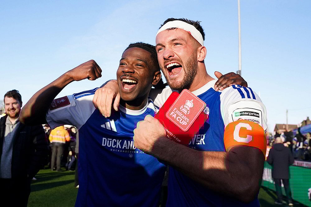 | Photo: Martin Rickett/PA via AP : Macclesfield FC goalscorers Paul Dawson, right and Isaac Buckley-Ricketts celebrate following the FA Cup third round soccer match between Macclesfield Town and Crystal Palace, at the Leasing.com Stadium, Macclesfield, England.