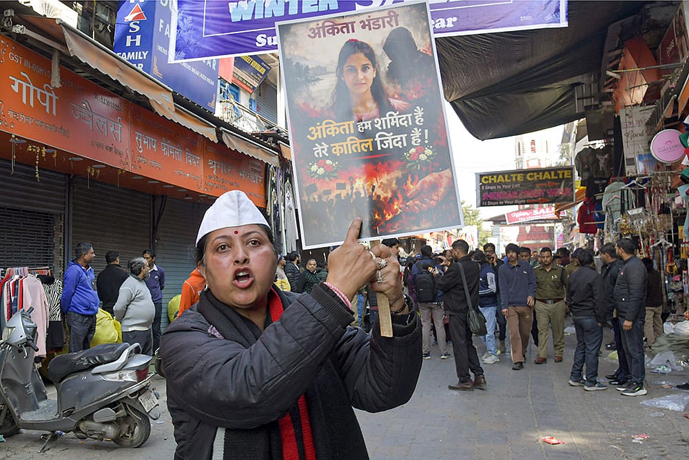 | Photo: PTI : A protester holds a placard during a statewide bandh called by social groups and political organisations over the Ankita Bhandari murder case, in Dehradun.