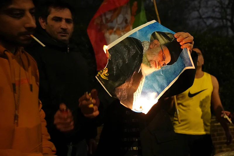 Alastair Grant : A picture of Ayatollah Ali Khamenei is set alight by protesters outside the Iranian Embassy in London, Monday, Jan. 12, 2026.