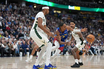 | Photo: AP/David Zalubowski : Denver Nuggets guard Peyton Watson, center, loses control of the ball while driving between Milwaukee Bucks center Myles Turner, front, and guard Gary Harris in the second half of an NBA basketball game in Denver.