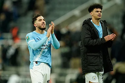 Photo: AP/Dave Thompson : Manchester Citys Rayan Cherki, left, and Manchester Citys Nico OReilly applaud fans at the end of the English League Cup semifinal first leg soccer match between Newcastle and Manchester City in Newcastle, England.