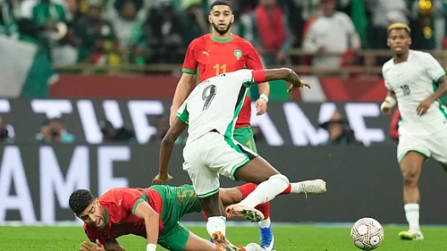 | Photo: AP/Mosaab Elshamy : Moroccos Adam Masina and Nigerias Victor Osimhen fight for the ball during the Africa Cup of Nations semi-final match on Wednesday, January 14, 2026.