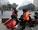 Source: IMAGO / Hindustan Times : Gig workers rest during a nationwide strike at Connaught Place on December 31, 2025 in New Delhi, India. Gig workers are striking on New Years Eve, demanding better pay, social security, and an end to 10-minute delivery mandates due to safety concerns and stress. While the strike aimed to disrupt high-demand New Years Eve services, the overall impact was mitigated by aggressive counter-measures from delivery platforms.