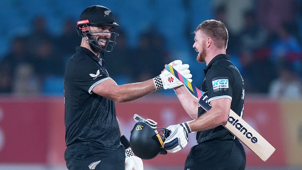 (AP Photo/Ajit Solanki) : New Zealands Daryl Mitchell, left, and New Zealands Glenn Phillips celebrate their win during the second One Day International cricket match between India and New Zealand in Rajkot, India, Wednesday, Jan. 14, 2026