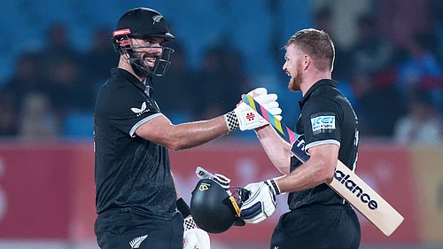 (AP Photo/Ajit Solanki) : New Zealands Daryl Mitchell, left, and New Zealands Glenn Phillips celebrate their win during the second One Day International cricket match between India and New Zealand in Rajkot, India, Wednesday, Jan. 14, 2026