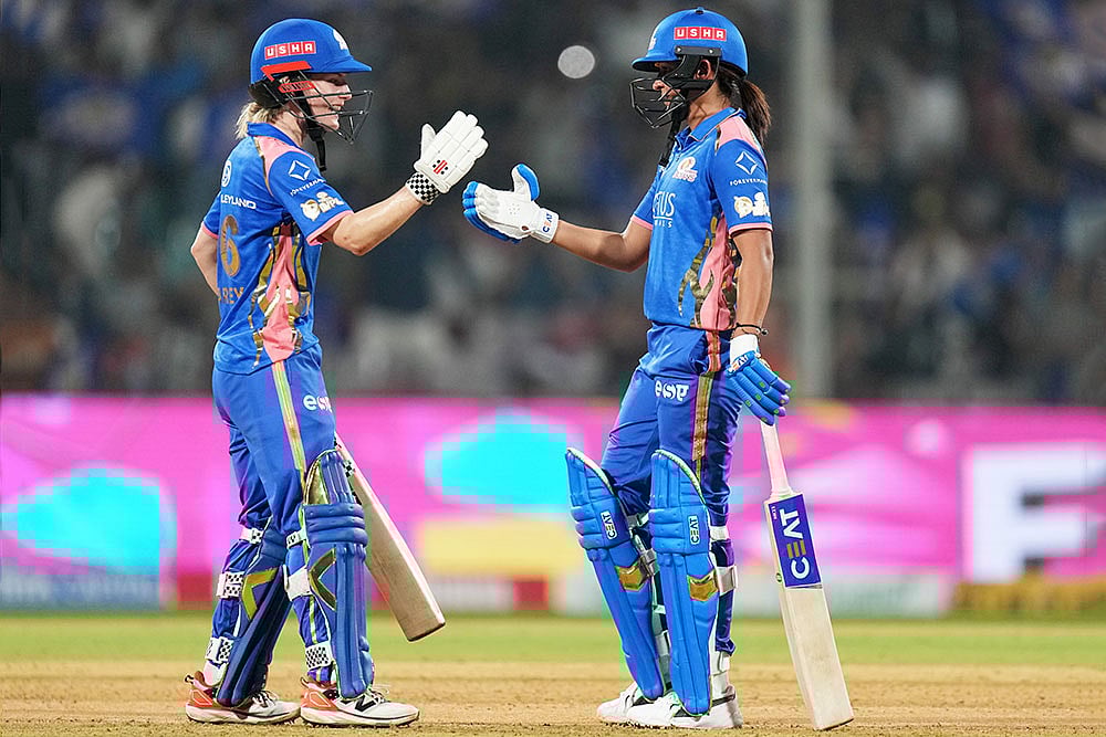 | Photo: PTI/Kunal Patil : Mumbai Indians captain Harmanpreet Kaur, right, and teammate Nicola Carey celebrate after winning the Womens Premier League (WPL) 2026 T20 cricket match against Gujarat Giants, at the DY Patil Stadium, in Navi Mumbai.