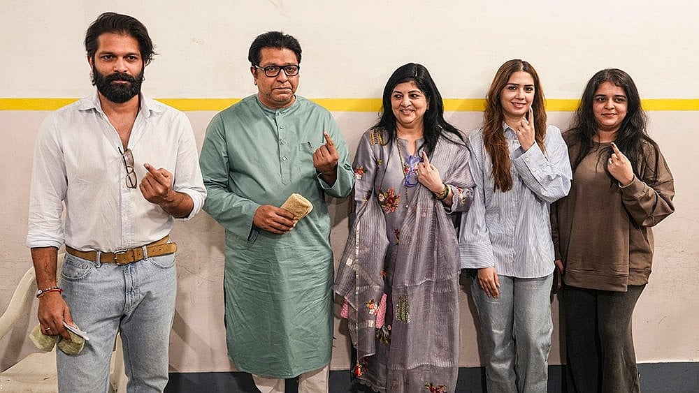 | Photo: PTI/Kunal Patil : Maharashtra Navnirman Sena (MNS) chief Raj Thackeray with party leader and his son Amit Thackeray and other family members, shows his ink-marked finger after casting a vote in the Brihanmumbai Municipal Corporation (BMC) polls, in Mumbai.