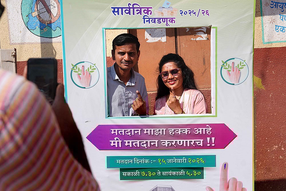 | Photo: Dinesh Parab/Outlook : Voters pose infront of a selfie counter near the polling station