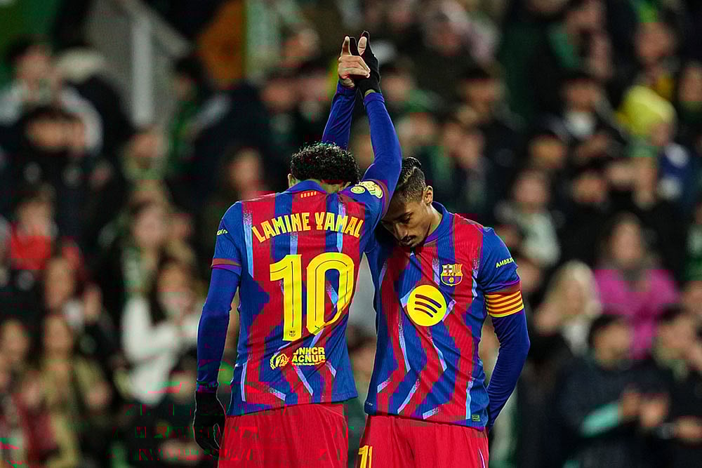 | Photo: AP/Miguel Oses : Barcelonas Lamine Yamal, left, celebrates after scoring his sides second goal with his teammate Barcelonas Raphinha during the Copa del Rey round of 16 soccer match between Racing Santander and Barcelona, in Santander, Spain.