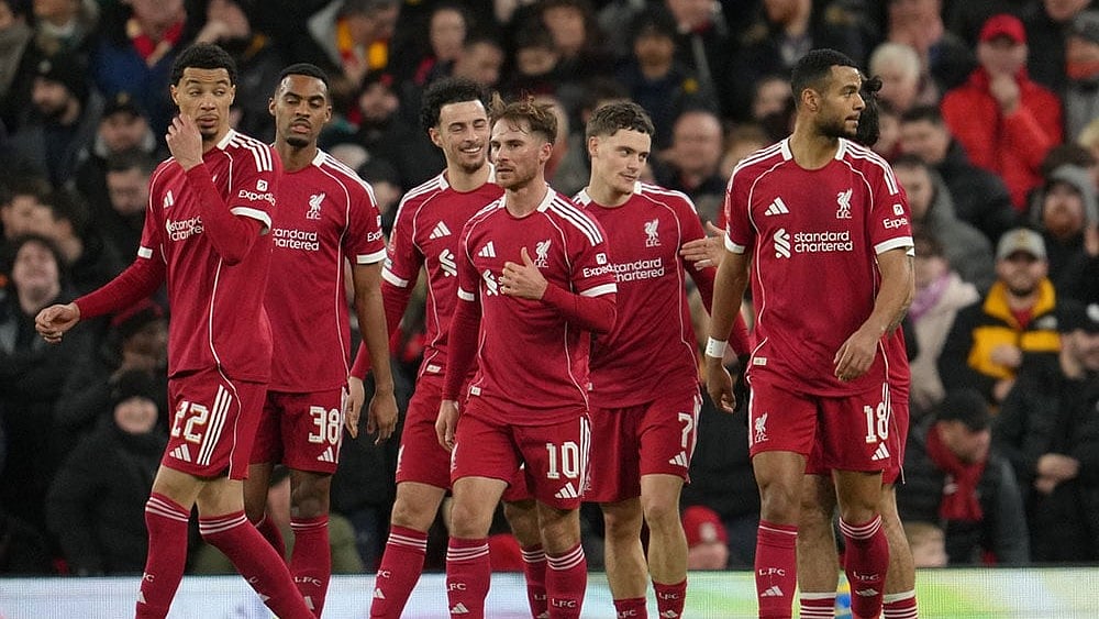 | Photo: AP/Jon Super : Premier League 2025-26 Live Scores, Saturday Goal Rush: Liverpool players walk to the ceneter after scoring during the FA Cup third round soccer match between Liverpool and Barnsley in Liverpool, England.