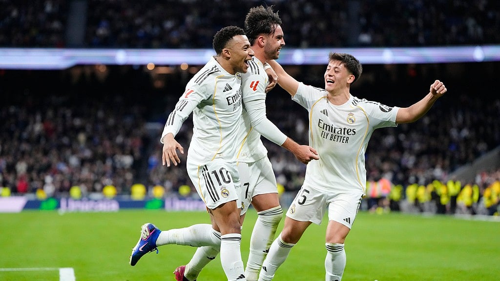 Photo: AP : Raul Asencio, centre, celebrates with teammates Kylian Mbappe, left, and Arda Guler after scoring his side's second goal during the Spanish La Liga match between Real Madrid and Levante in Madrid, Spain.