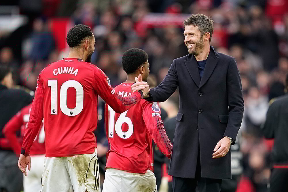 | Photo: AP/Dave Thompson : Manchester Uniteds head coach Michael Carrick, right, greets Manchester Uniteds Matheus Cunha after the English Premier League soccer match between Manchester United and Manchester City in Manchester, England.
