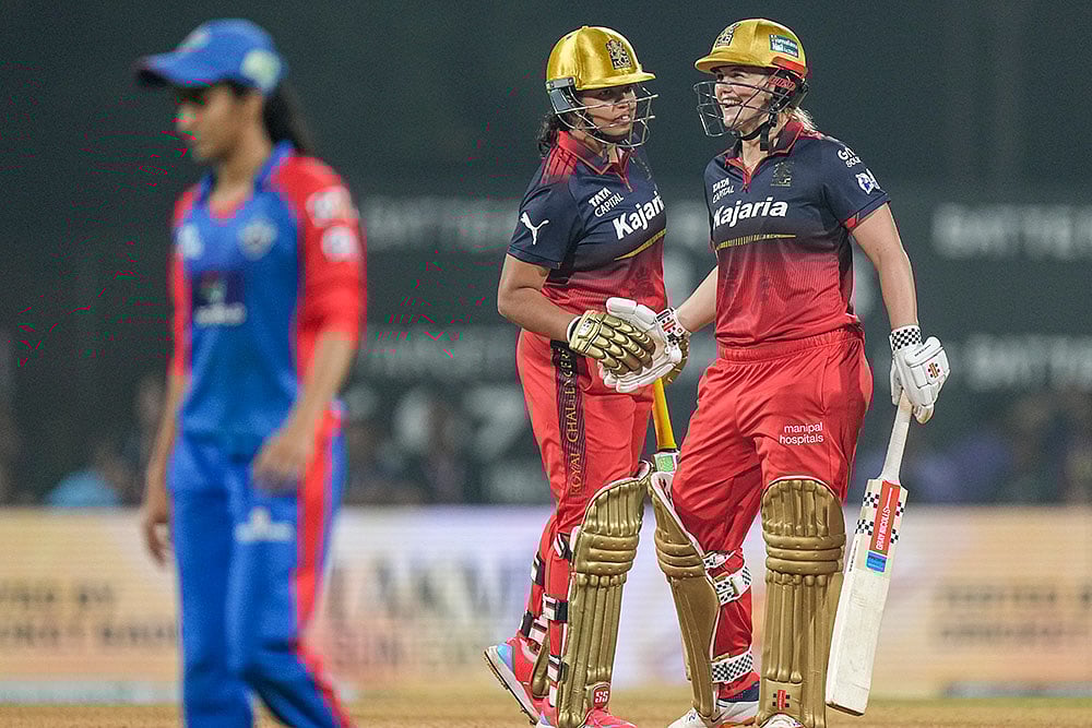 | Photo: PTI/Kunal Patil : Royal Challengers Bengalurus Richa Ghosh, left, shakes hands with teammate Georgia Voll at the end of play during the Womens Premier League (WPL) T20 cricket match between Royal Challengers Bengaluru and Delhi Capitals, at DY Patil Stadium, in Navi Mumbai.