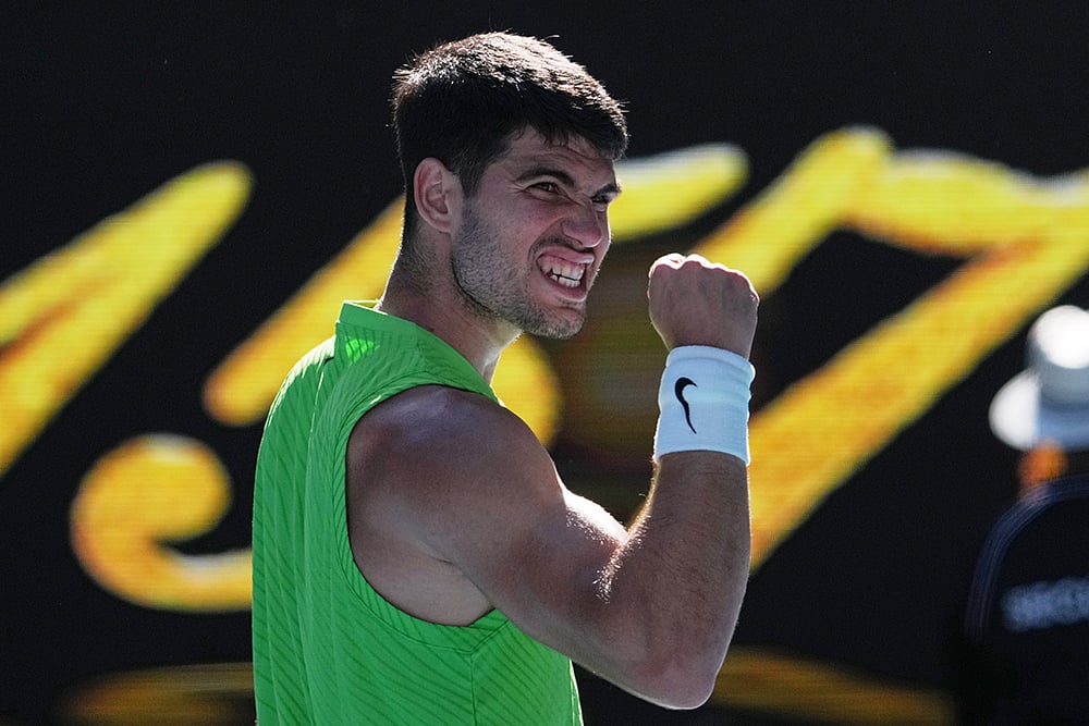 | Photo: AP/Dita Alangkara : Carlos Alcaraz of Spain celebrates after defeating Yannick Hanfmann of Germany in their second round match at the Australian Open tennis championship in Melbourne, Australia.