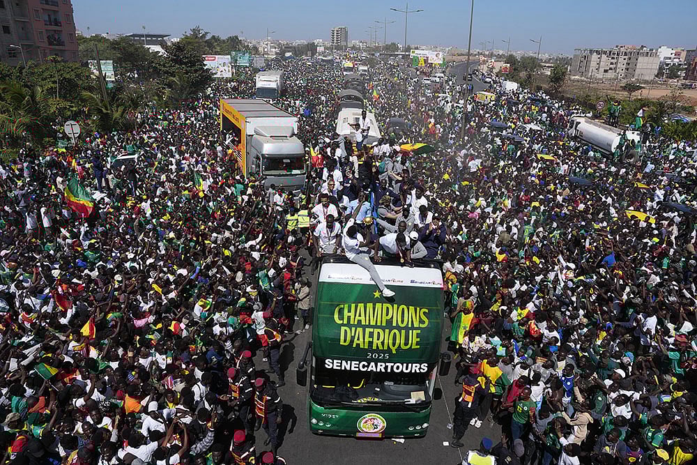 | Photo: AP/Misper Apawu : The Senegalese soccer team rides through thousands of cheering fans celebrating their victory in the Africa Cup of Nations soccer tournament, in Dakar, Senegal.