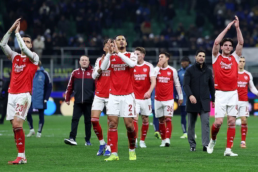 | Photo: Fabrizio Carabelli/PA via AP : Arsenals William Saliba (center), Mikel Merino (left), Declan Rice and team-mates applaud the fans after the UEFA Champions League match at the San Siro, Milan.